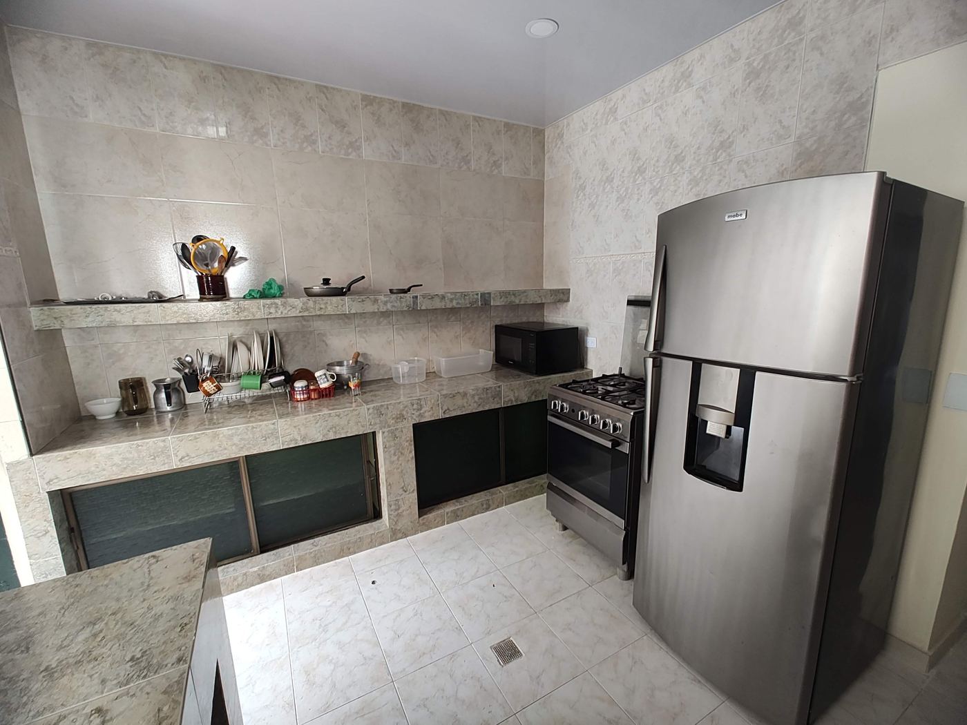 Equipped kitchen with fridge, oven and microwave