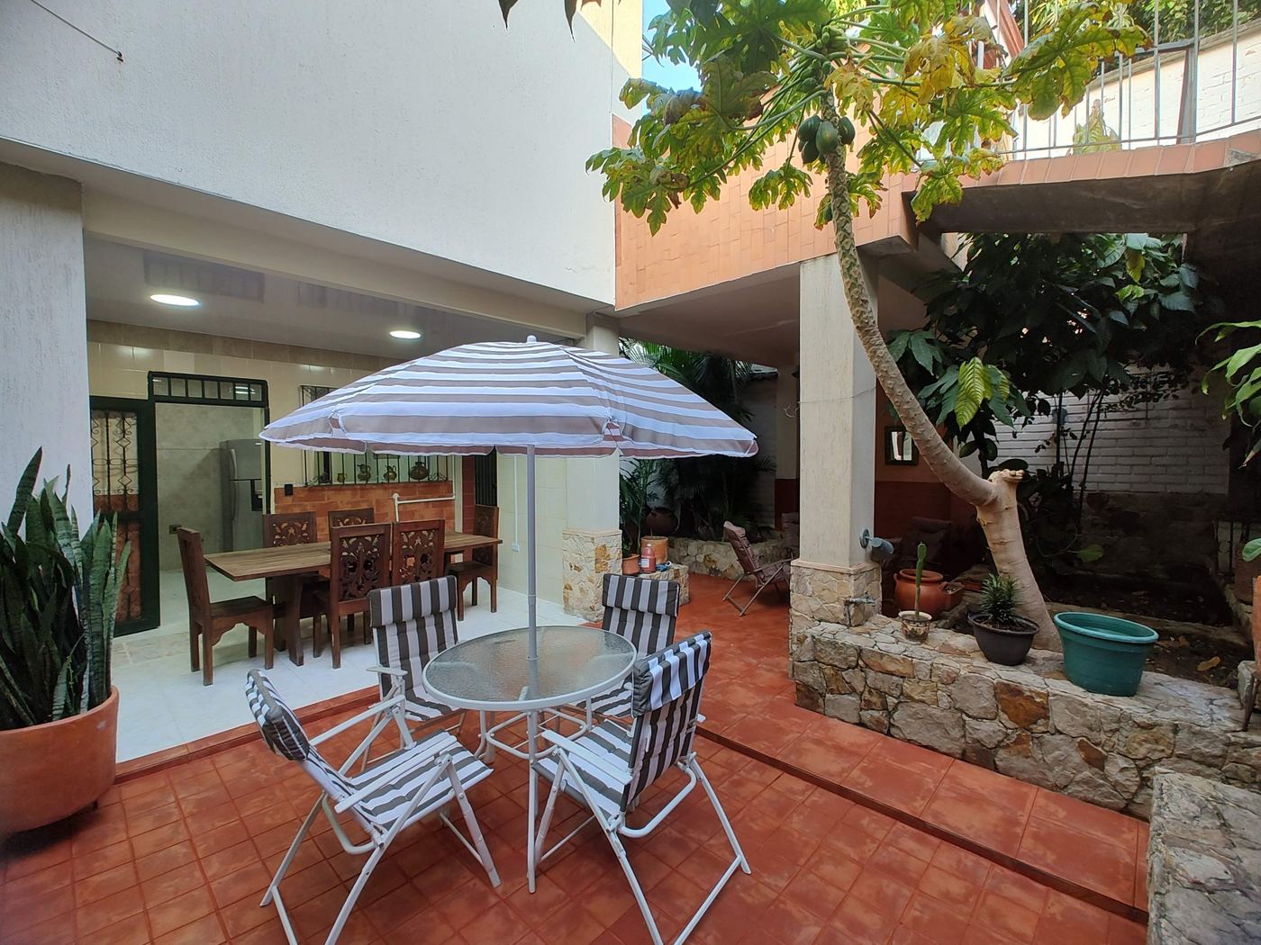 Herradura House patio with outdoor dining and the kitchen behind
