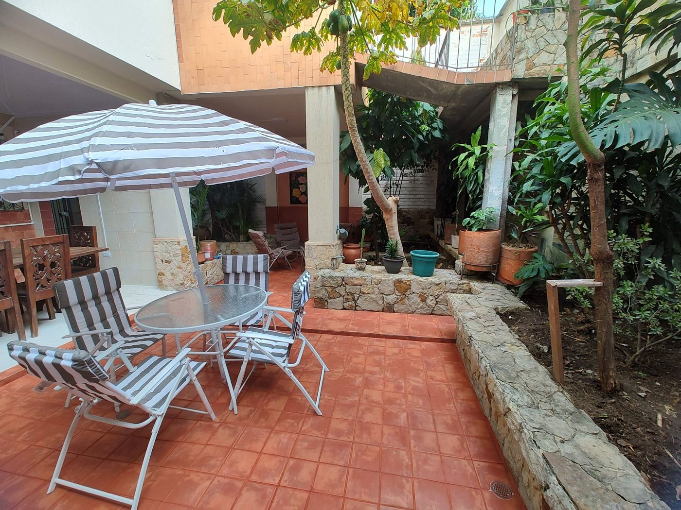 Patio with umbrella and gardens